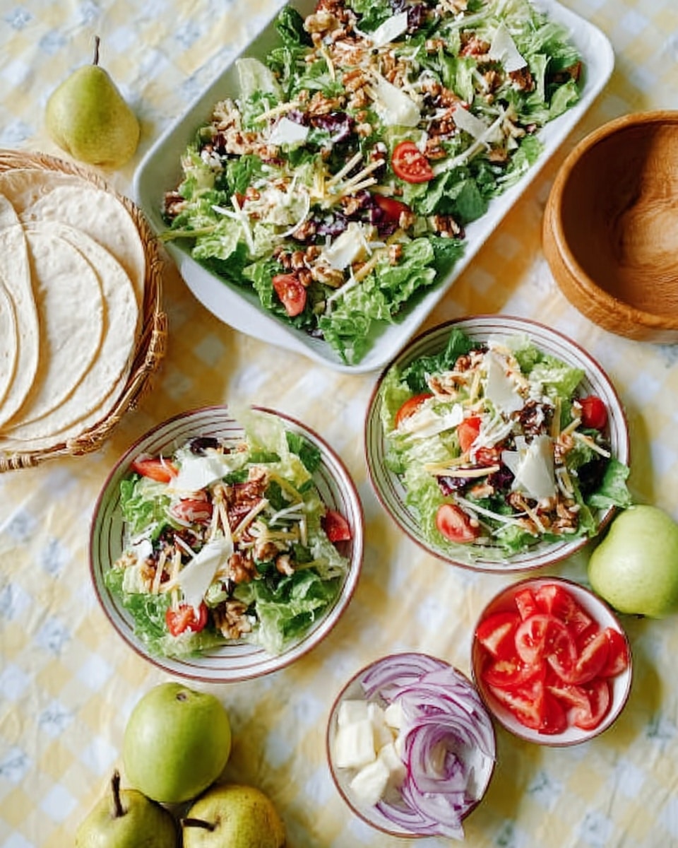 The image shows three white dishes on a white marbled surface. The largest dish is a rectangular white tray topped with a fresh salad made of green leafy lettuce, sliced cherry tomatoes, thin white cheese strips, chopped nuts, and small brown pieces that look like seeds or beans. There are two smaller round white plates, each holding similar salad layers with leafy greens, tomatoes, cheese strips, and nuts. Around the dishes, there are small white bowls holding sliced red tomatoes, chopped white cheese, and thinly sliced pale purple onions. Also visible are two whole green pears and a wooden bowl of folded soft white tortillas. The whole setting is on a pale yellow checkered cloth, and everything looks fresh and colorful. Photo taken with an iphone --ar 4:5 --v 7