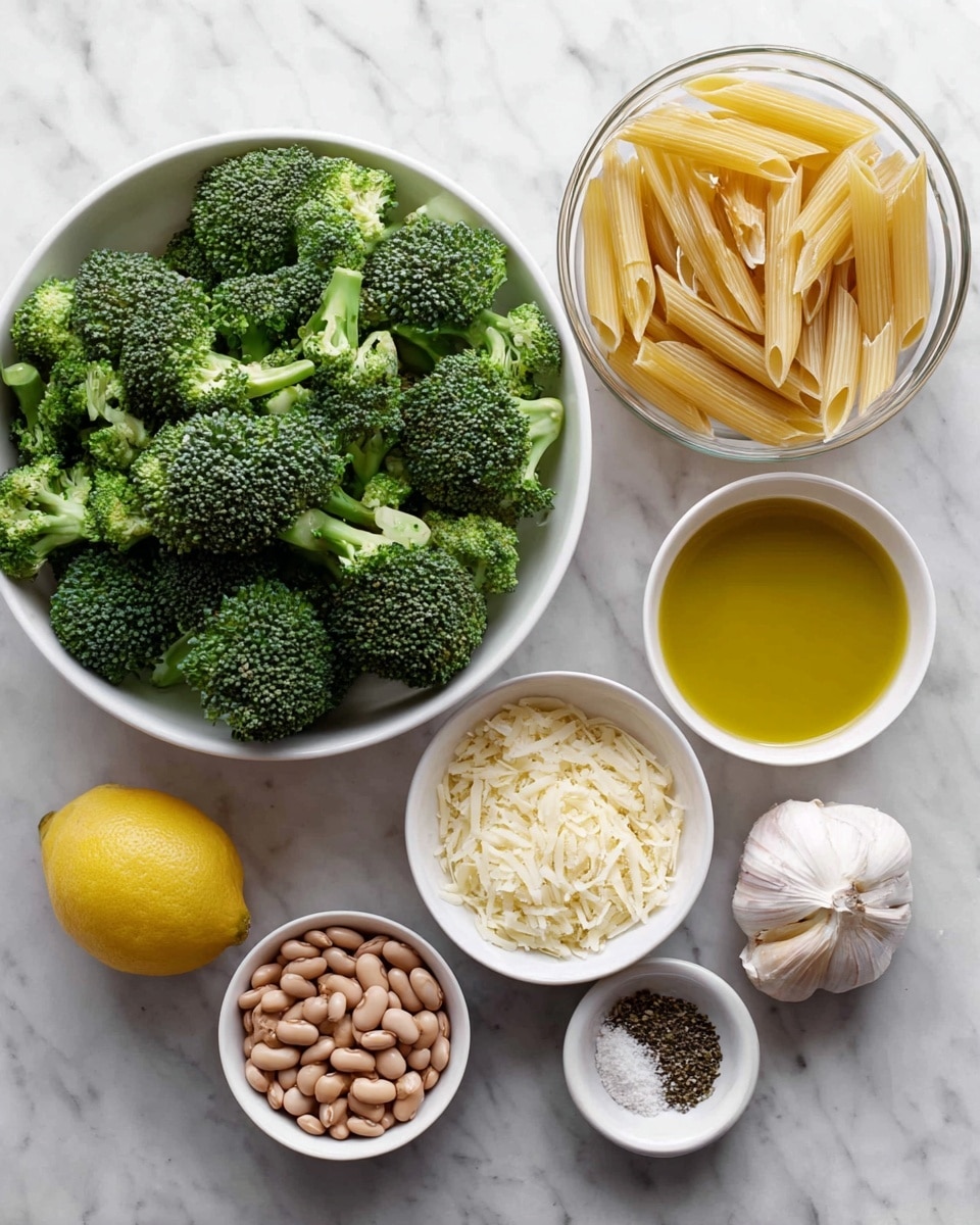 A top view of several white bowls on a white marbled surface. The largest bowl is filled with dark green broccoli florets that show fine texture in the buds and stems. To the right, a clear glass bowl holds pale yellow uncooked penne pasta, each tube smooth and aligned loosely. Below the broccoli, a small white bowl contains light brown pinto beans with a mottled pattern. Next to it, another white bowl has finely grated pale cheese with a fluffy texture. Near the cheese bowl, there are two whole garlic cloves with smooth off-white skin. A bright yellow lemon with a slightly bumpy peel sits below the bowls. To the right of the lemon, a white bowl has golden yellow olive oil with a shiny surface. At the bottom right, a small white bowl holds a mix of black pepper and salt granules. Photo taken with an iphone --ar 4:5 --v 7
